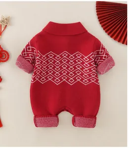 Detailed knit texture of red baby onesie with white diamond pattern and festive decor