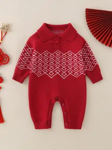 Infant red knitted festive romper with white geometric patterns and traditional buttons