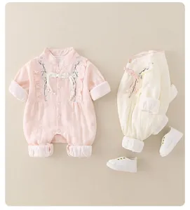 Detail of baby rompers with floral embroidery and traditional Chinese frog buttons