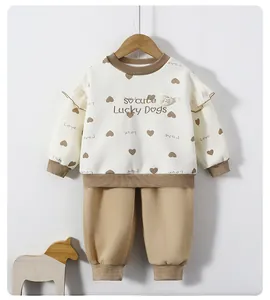 Detail of girls' cream sweatshirt with heart embroidery and khaki jogger pants set