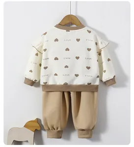 Detail view of toddler sweatshirt set with ruffled shoulders and heart print design