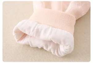 Detail of pink floral baby romper featuring soft ribbed cuffs and delicate lace texture