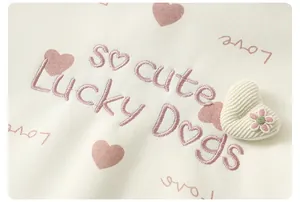 Close-up of pink heart embroidery and 3D corduroy patch on baby girl sweatshirt