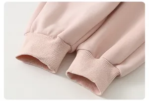 Close-up of soft pink ribbed cuffs on a toddler girl cotton sweatshirt set for spring