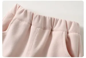 Detail view of pink cotton kids pants with elastic waistband and high-quality stitching
