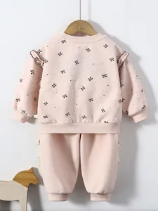 Pink cotton sweatshirt set for girls featuring all-over bow prints and ruffle shoulders