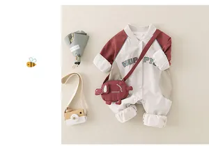 Baseball style baby romper in burgundy and beige with HUPPY letters and a small dog bag