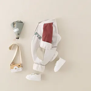 Baby boy long sleeve cotton romper with cartoon lettering and color block design