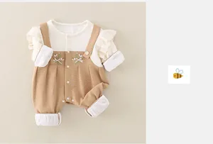 Detail of baby cotton romper featuring floral embroidery and elegant ruffled collar lace