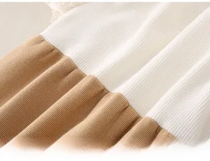 Close-up of baby romper showing soft rib-knit fabric and delicate lace trim detail