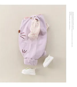 Flat lay of baby girl lilac overalls with striped top and cute cat embroidery details