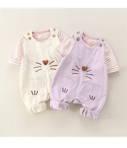 Detail of baby cat overalls with striped shirt, soft cotton fabric and snap buttons