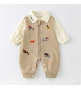 Detail of baby cotton jumpsuit with treasure embroidery and cute cartoon dog patterns
