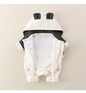 Detail of baby panda hooded romper with dual zippers and 3D ears on creamy white fabric