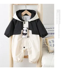 Detail of baby panda hooded romper showing contrast color design and snap button closure