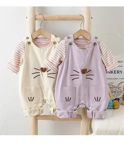 Detail of baby girls' cotton overalls with cute cat embroidery and striped long sleeve shirts