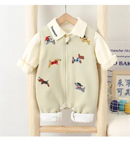Close-up of cotton baby romper with cute dog embroidery and zipper detail on wooden rack