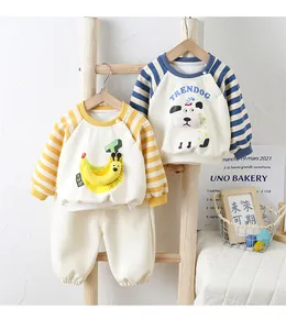 Detail of fleece-lined baby sweatshirts with cartoon 3D banana and dog appliques