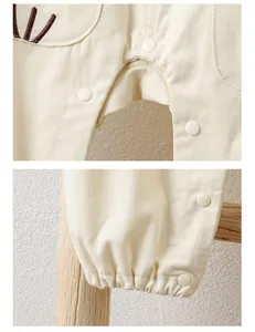 Detail of baby romper featuring snap button closures and soft cotton fabric texture