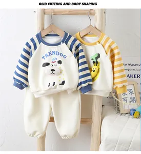 Detail of baby striped cotton sweatshirts and matching trousers on a wooden hanger