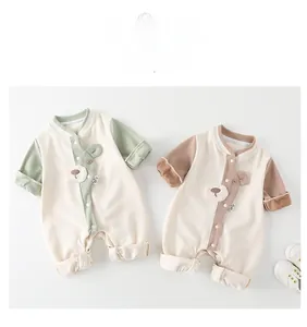 Detail of baby romper with ribbed collar, cute bear embroidery and snap-button closure