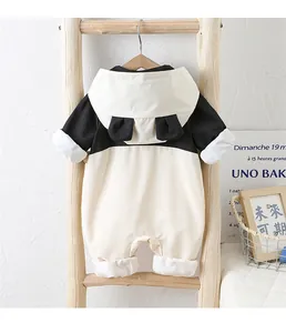 Detail of baby panda hooded romper hanging on wooden ladder for autumn