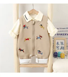 Detail of baby cotton romper featuring embroidered puppy patterns and Treasure collar text