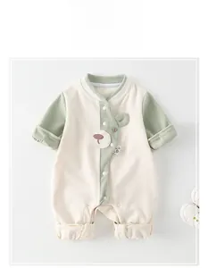 Detail of baby romper with waffle texture fabric, bear applique and snap button closure