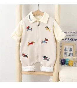 Detail of cream long-sleeve baby romper with cute dog embroidery and Treasure logo