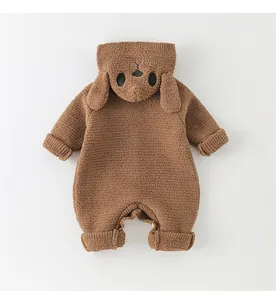 Detail of baby hooded romper featuring brown plush fabric and cute dog face embroidery