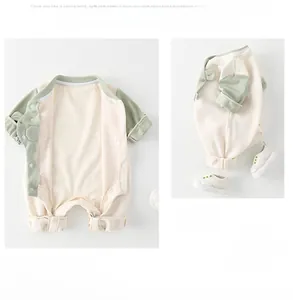 Detail of baby waffle cotton romper with snap buttons and matching white infant shoes