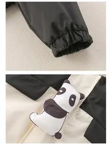 Detail of waterproof baby romper with elastic black cuffs and cute 3D panda patch design