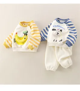 Detailed view of baby cotton long-sleeved sweatshirts featuring cartoon banana and dog motifs