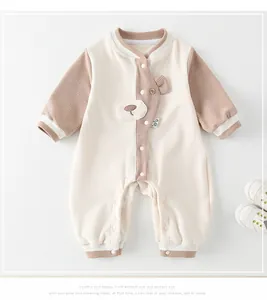 Detail of baby waffle knit romper featuring a 3D bear motif and snap-button closure