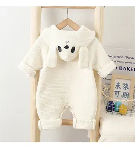 Detail of white fleece baby romper featuring cozy animal hood with soft 3D ears