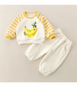 Detailed flat lay of toddler two-piece tracksuit with cartoon banana and striped sleeves