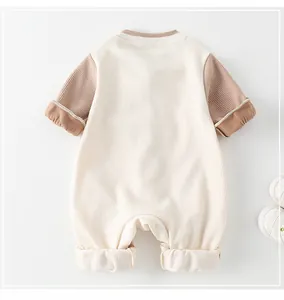 Detailed back view of a ribbed knit baby romper with khaki raglan sleeves and soft fabric