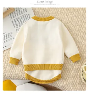 Détail de l'ensemble en tricot pour bébé avec finitions jaunes sur laine douce