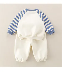 Detail view of baby two-piece set featuring striped raglan sleeves and ribbed cuffs