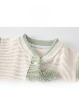 Close-up of ribbed cotton baby romper neck with color-block design and snap buttons
