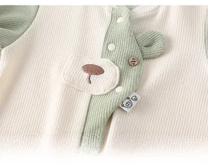 Close-up of baby romper waffle fabric texture with cute bear patch and wood button