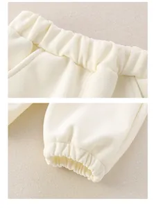 Detail of baby waffle knit trousers featuring elastic waistband and ribbed ankle cuffs