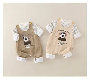 Detail of infant corduroy romper set featuring striped sleeves and cartoon dog embroidery