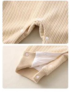 Detail view of beige corduroy baby romper showing snap buttons and ribbed cuffs for comfort