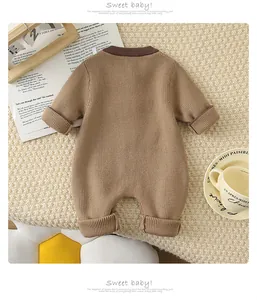 Close-up of knit texture and ribbed neckline on brown baby romper displayed on a blanket