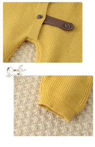 Detail of baby knit romper with vintage buttons and ribbed cuffs in mustard yellow