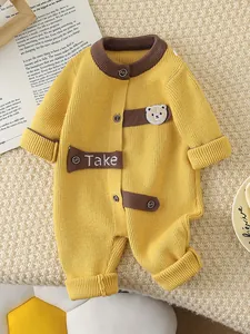 Knitted ginger yellow baby romper with brown button details and bear patch for infants