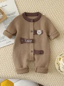 Newborn baby knitted romper in camel brown with bear patch and button closure