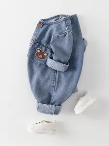 Pelele vaquero para bebé en azul claro con bordado de oso y botones de madera