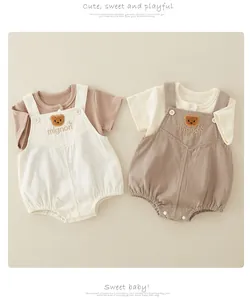 Detailed view of baby cotton ribbed short sleeve t-shirts and bear embroidery overalls